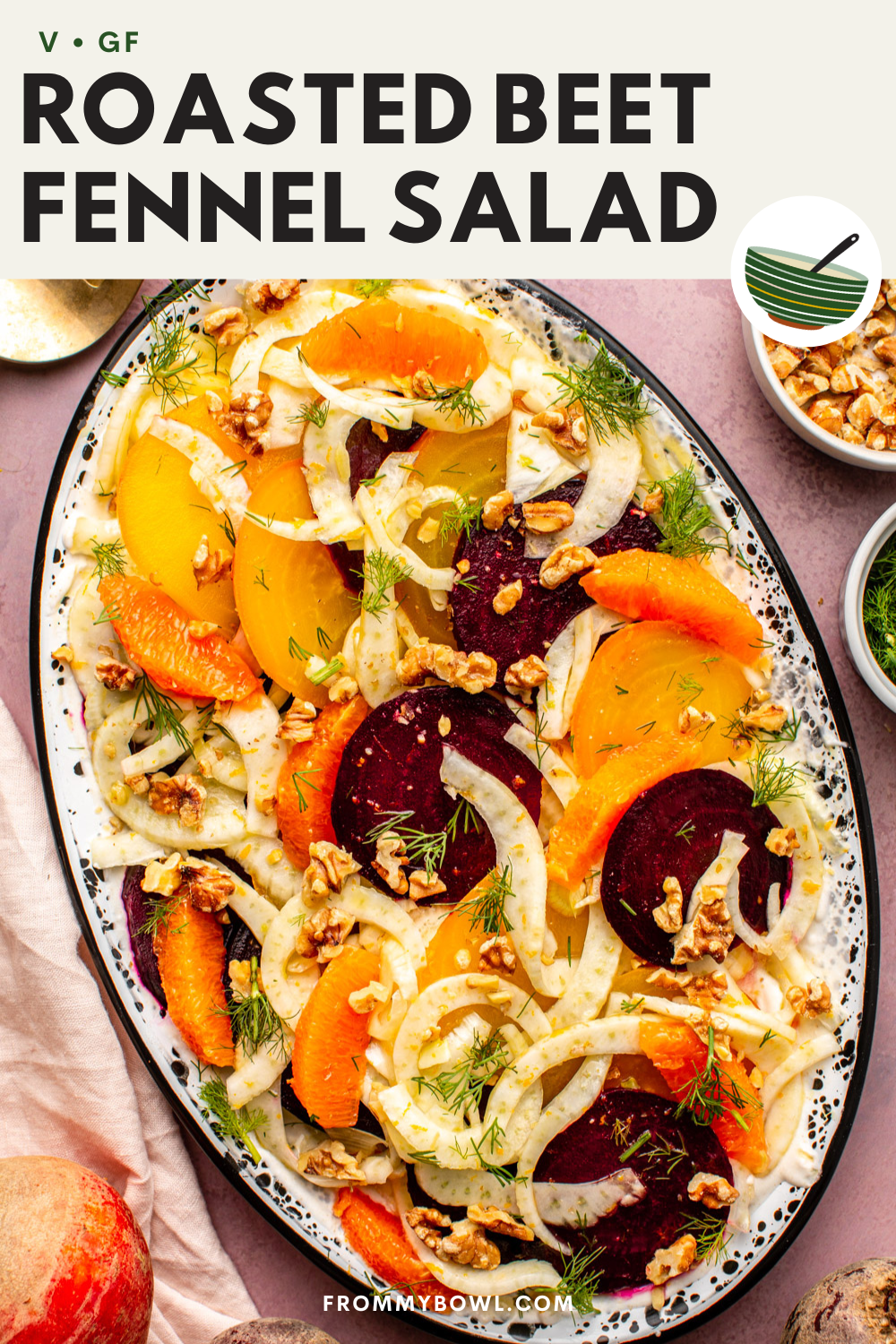 roasted beet fennel salad served on a wide oval plate topped with fresh dill and chopped walnut