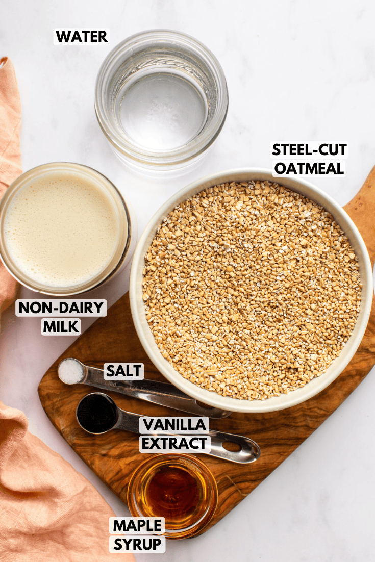 ingredients for steel cut oats laid out on marble kitchen countertop