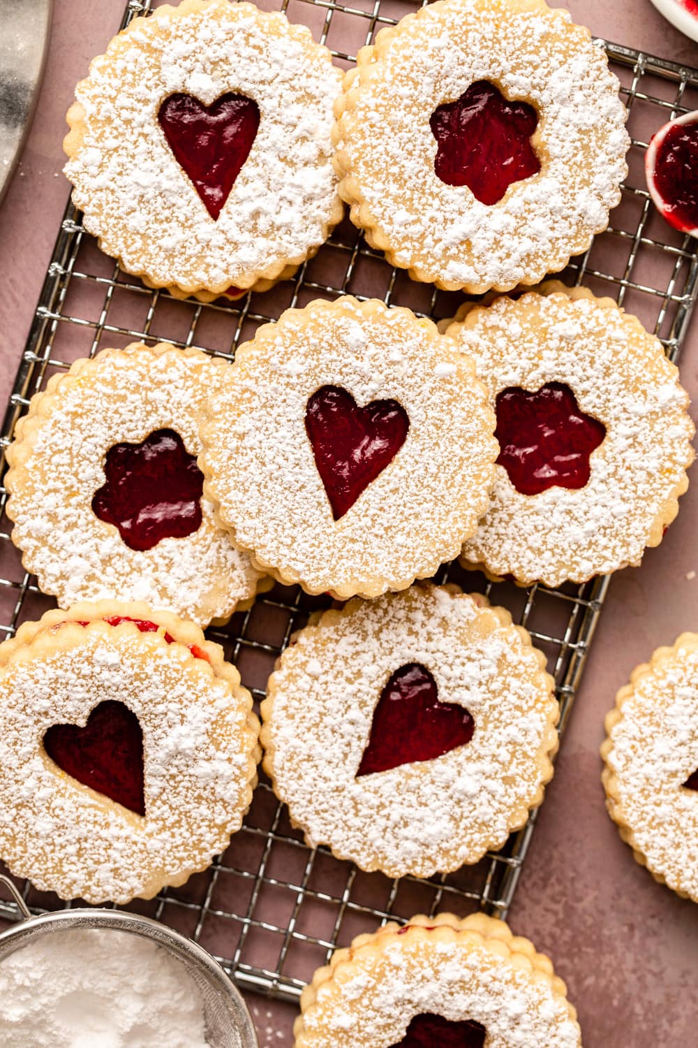 assembled vegan linzer cookies laid out on a cooling rack