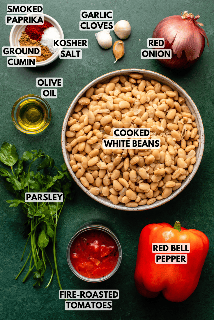 ingredients for sweet and smoky white beans laid out on a dark green backdrop