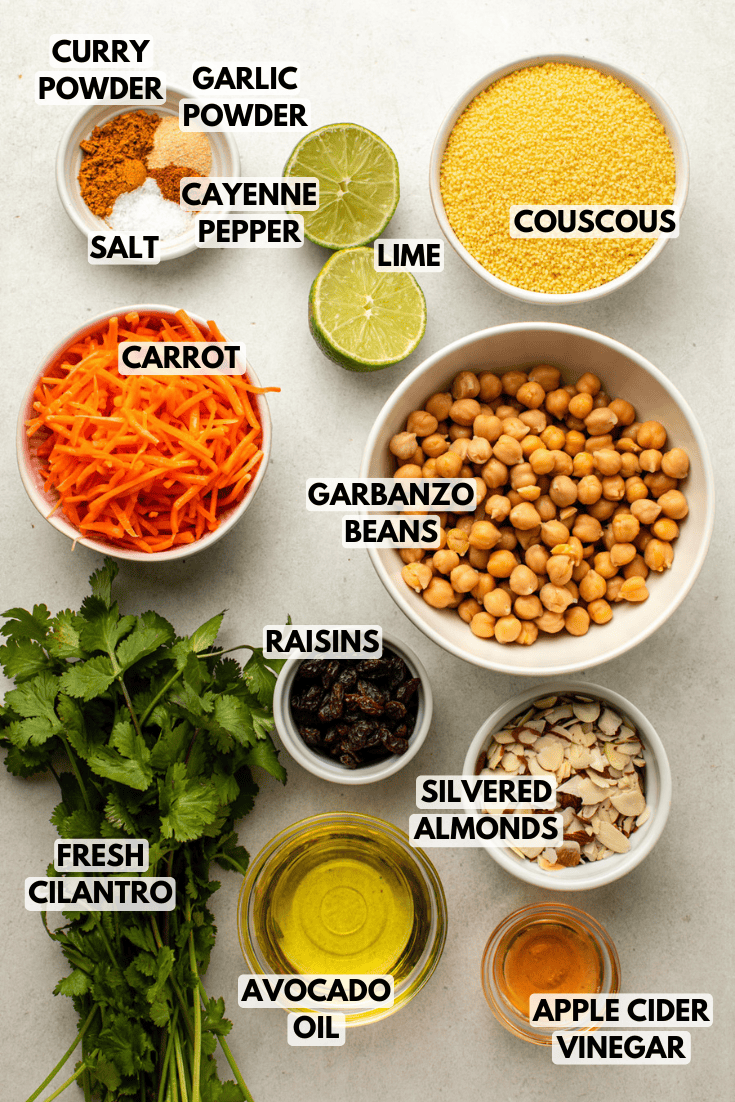 ingredients for curry chickpea salad laid out on a marble kitchen countertop