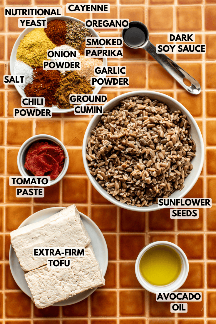 ingredients for vegan taco meat laid out on an orange tiled backdrop