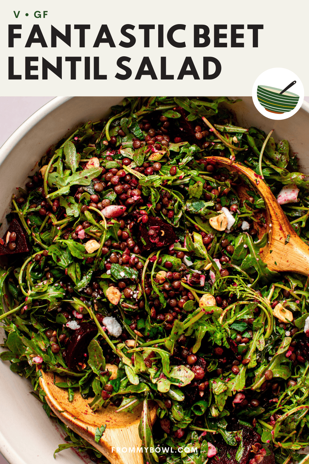 close-up of a beet and lentil salad in a white ceramic bowl on a kitchen countertop, with a wooden spoon mixing the salad