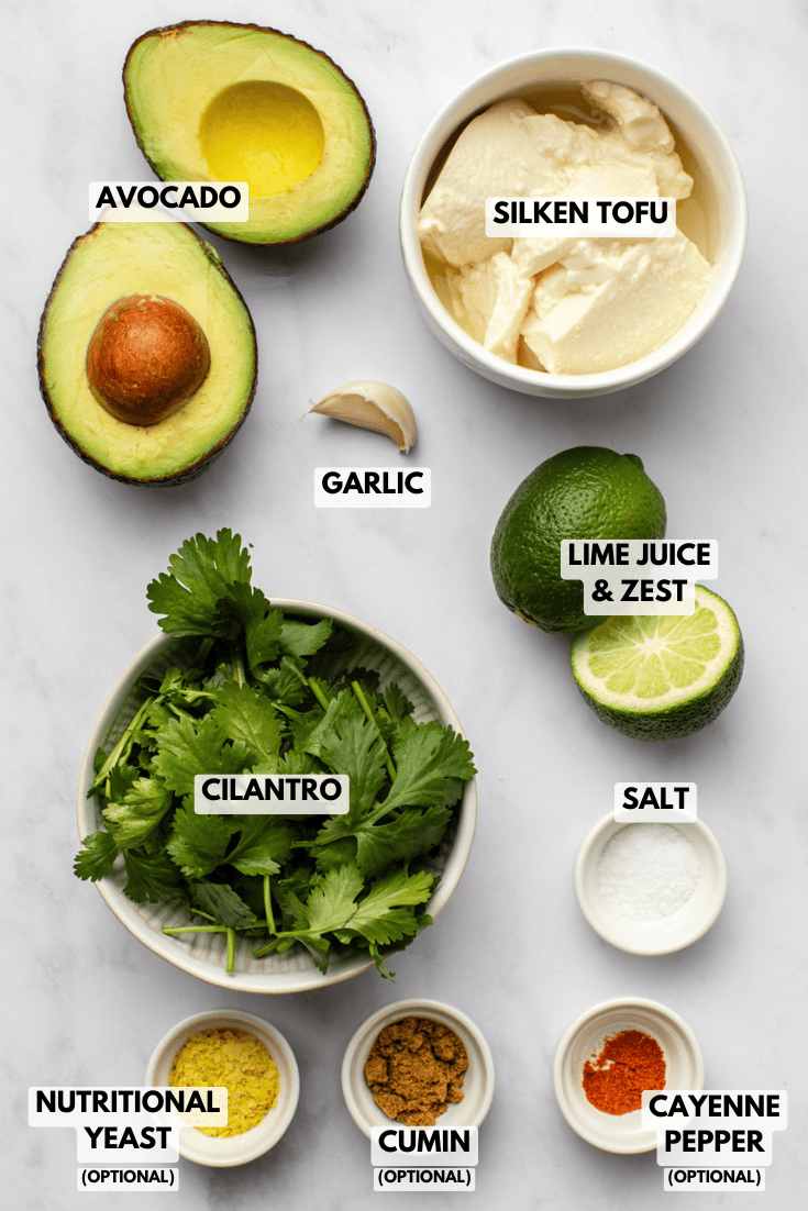 all the ingredients for the avocado crema are spread out across the kitchen countertop, arranged neatly for preparation.