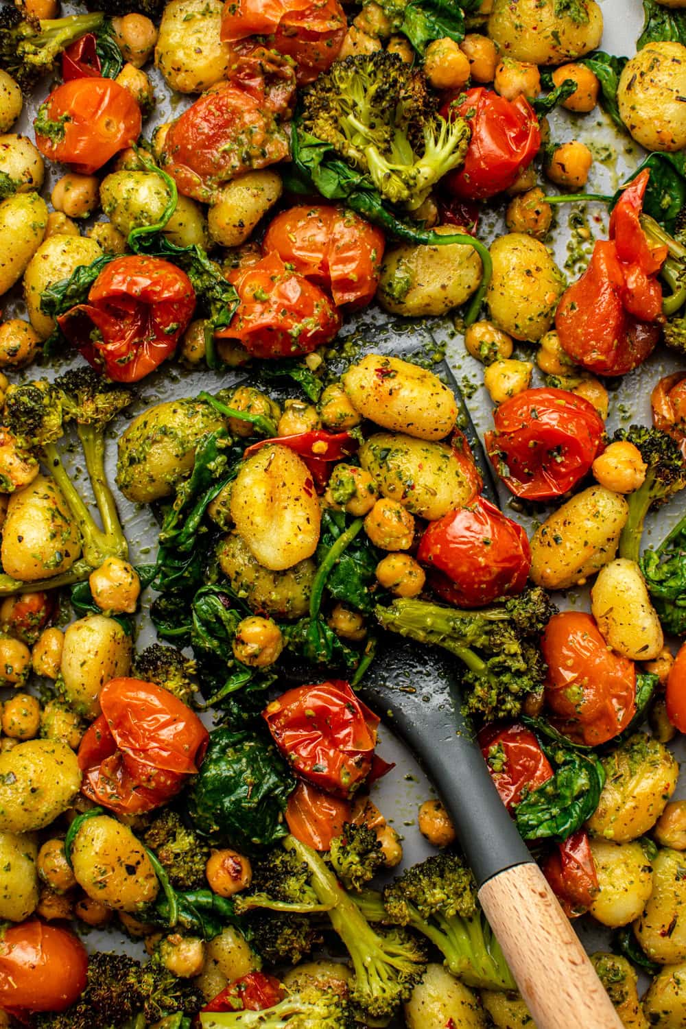 freshly baked sheet pan gnocchi served on a tray, photographed in a close-up view with crispy edges and roasted ingredients visible.