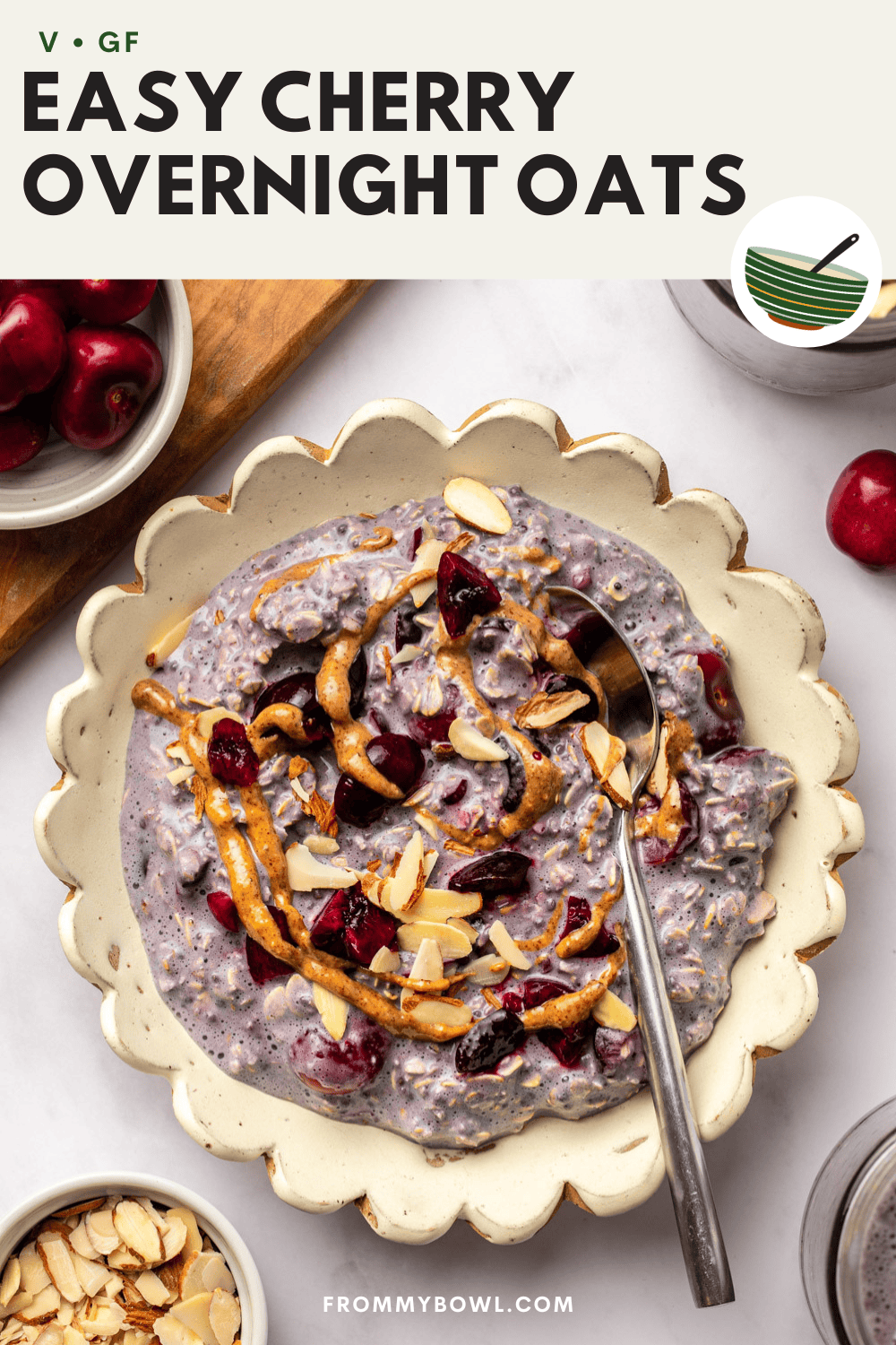 creamy cherry overnight oats in a bowl with almond butter, cherries, and sliced almonds.